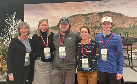 UNE students Troy Fowler and Jake Tobin pose with representatives from Maine's outdoor economy at the Maine Outdoor Economy Summit in Rockland